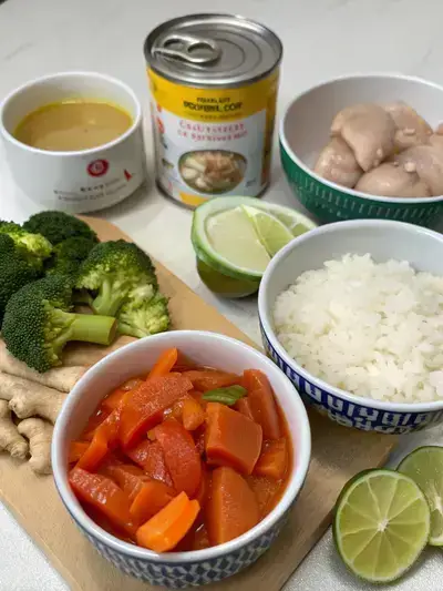Ingredients for Thai coconut curry displayed on a kitchen table.